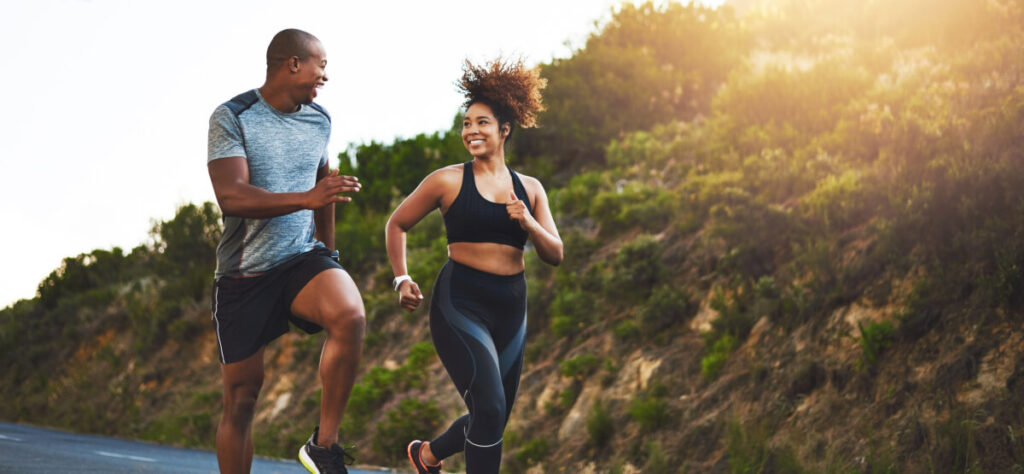Shot of a young couple out running together