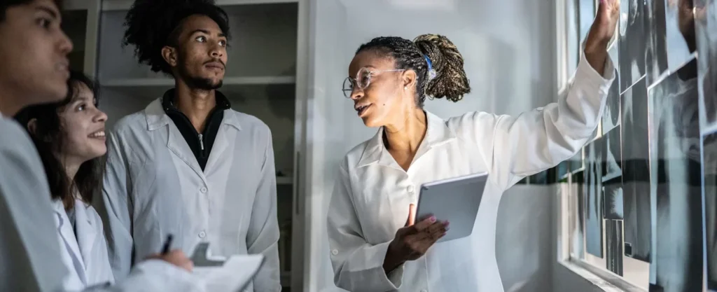 African American medical instructor explains about Xrays to her medical students