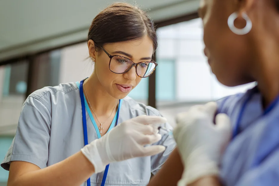 nurse injecting a patient