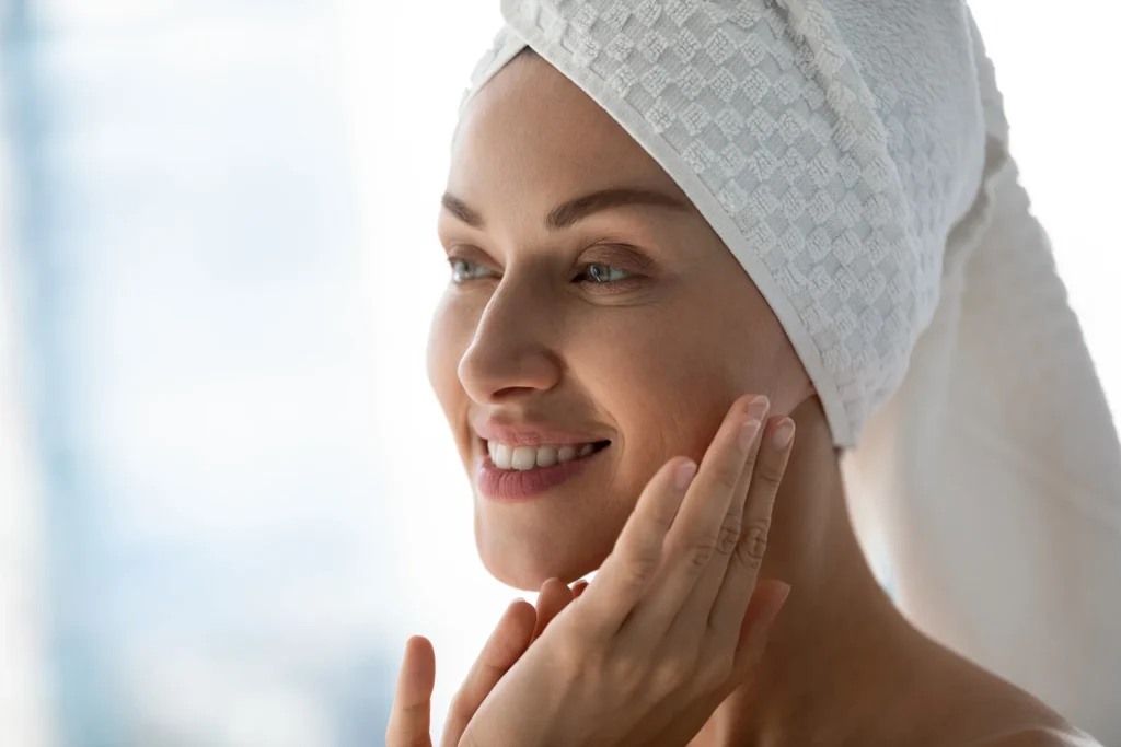 a woman touches her face after bath