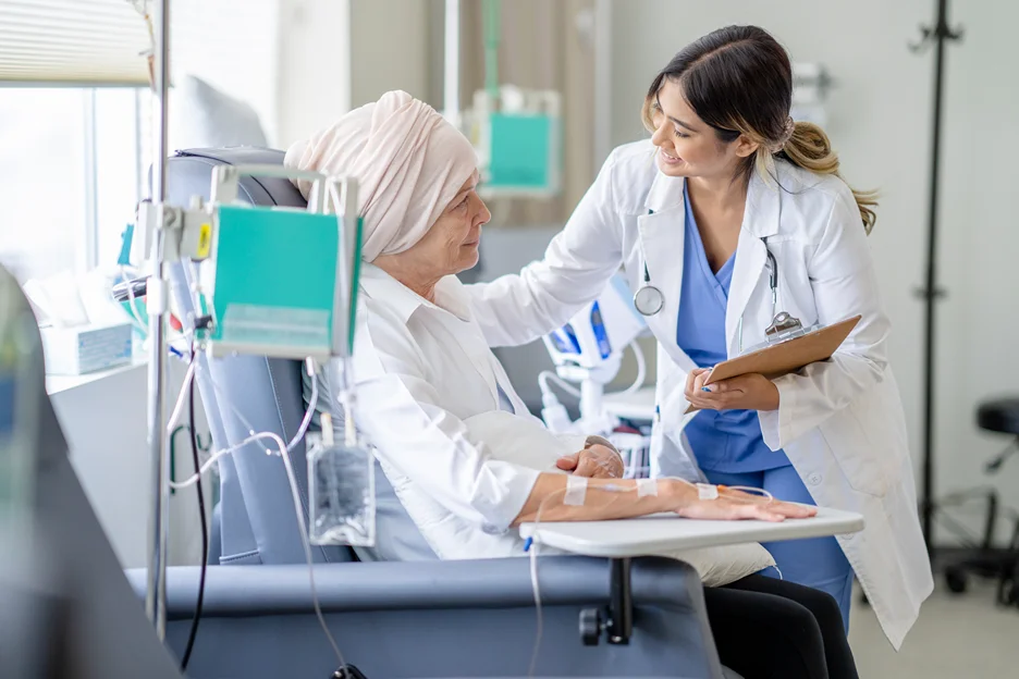 a doctor examining a cancer patient