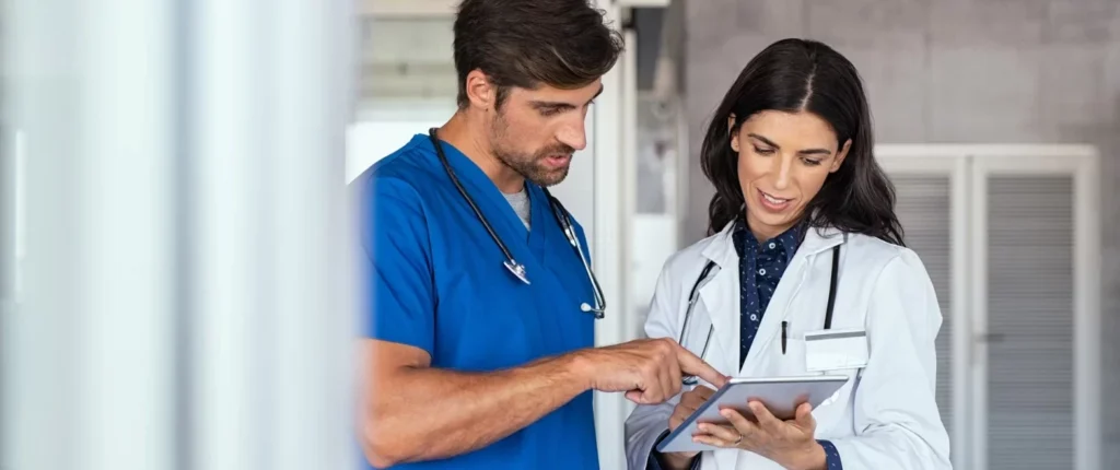 A male doctor giving instruction to his lady assistant.