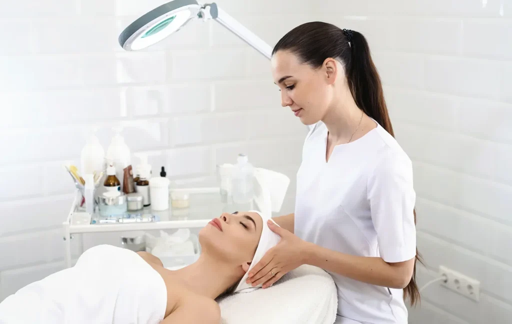 esthetician performs facial treatment on her client