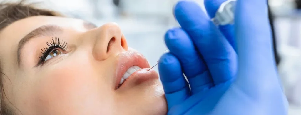 Woman having lip filler treatment.