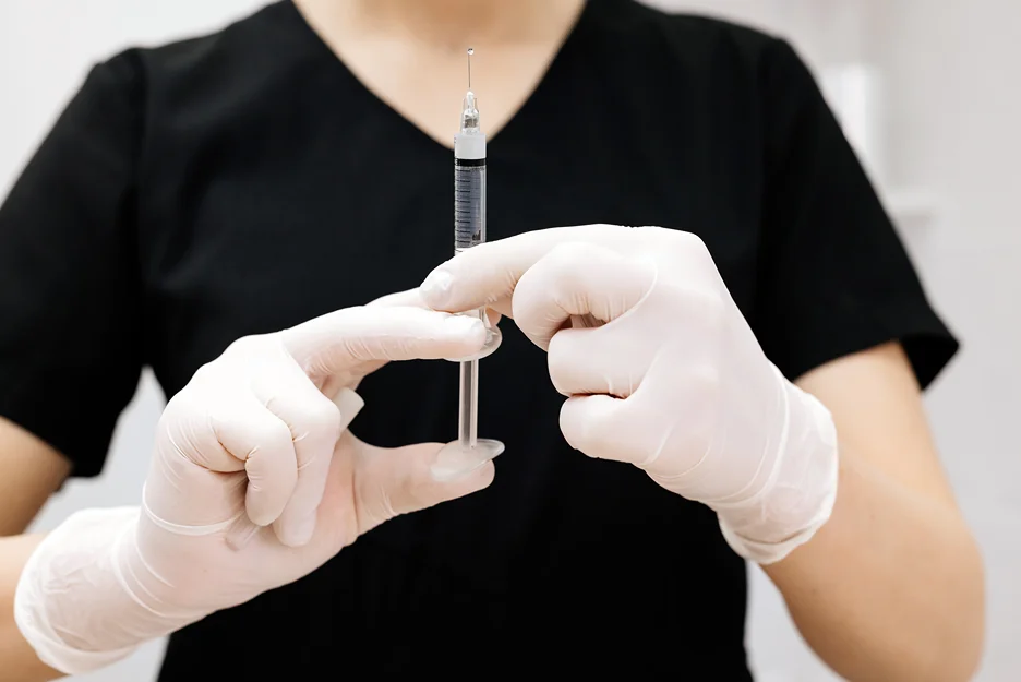 a provider prepares pdrn injections for hair regrowth treatment