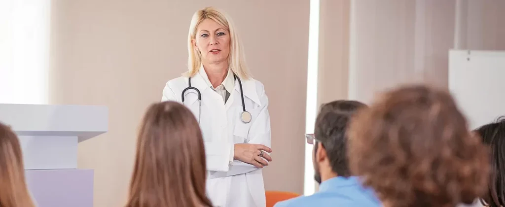 medical instructor gives lecture to her students about anatomy