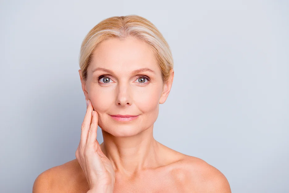 a matured woman touches her smooth skin 