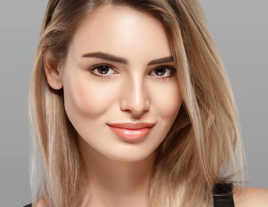 a woman with clear, smooth skin after using derma roller