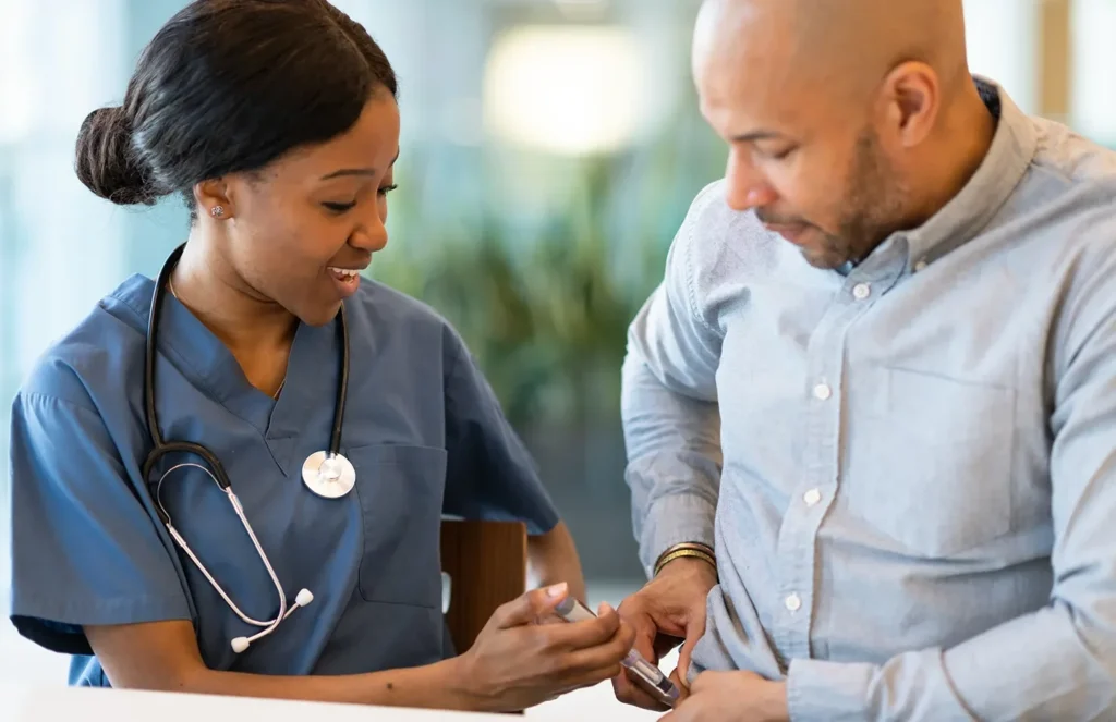 a nurse assists a male patient in administering tirzepatide injection