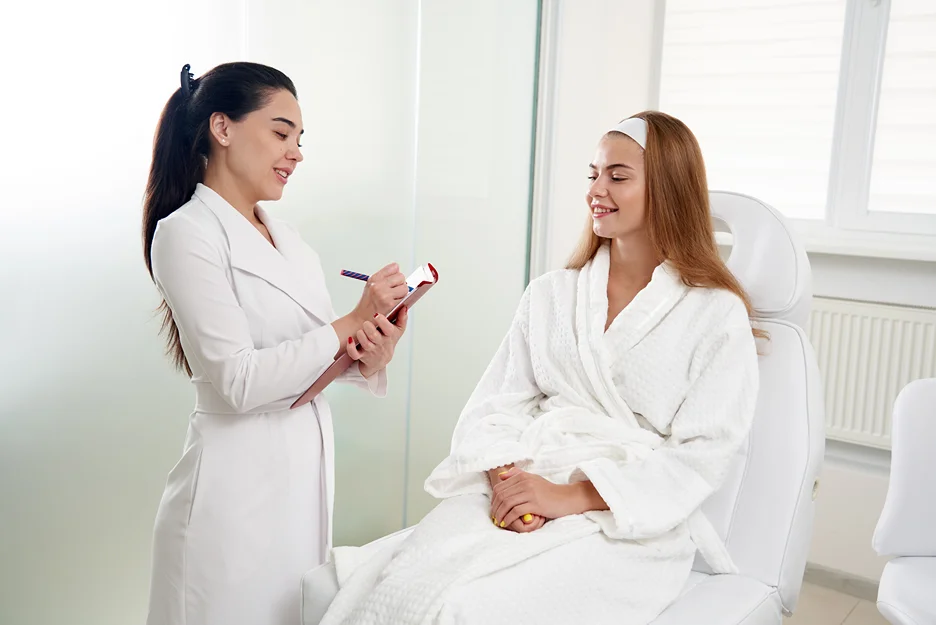 the provider taking notes during microneedling pen consultation
